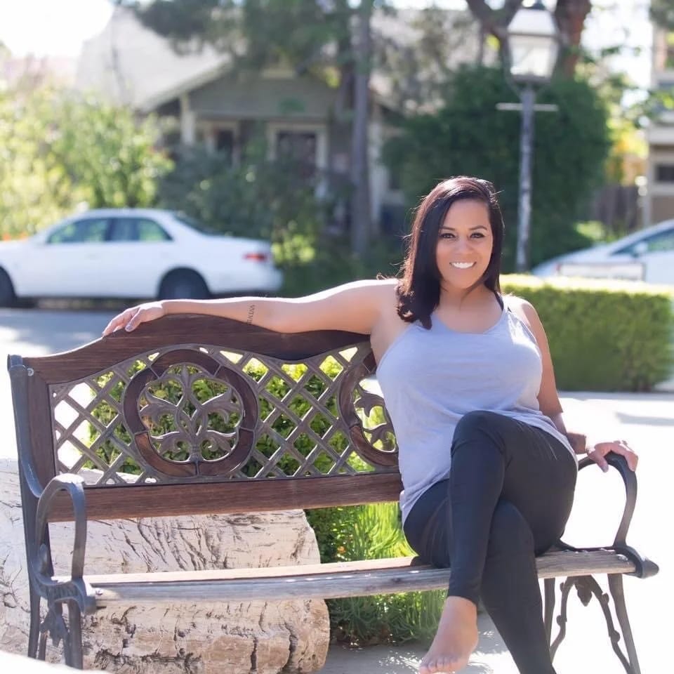 Bryana “Bree” Meyers, owner and artistic director, on a bench in Old Town Tustin.