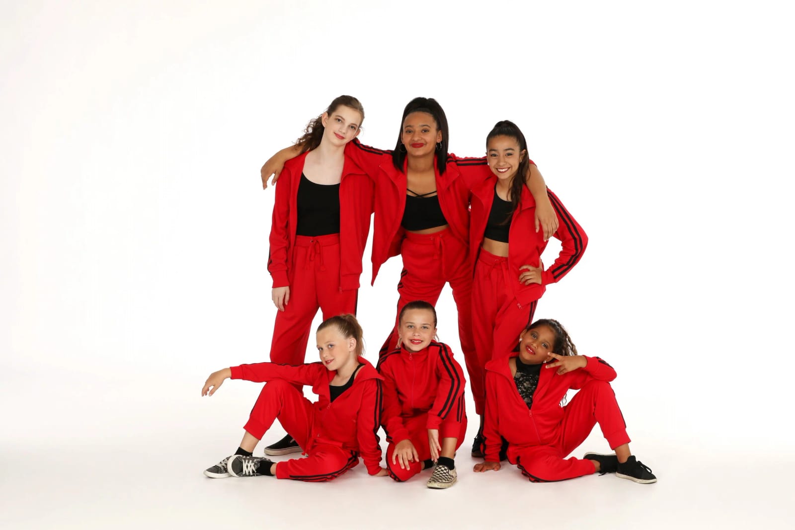 Our hip-hop dancers in red tracksuits on the white studio backdrop.