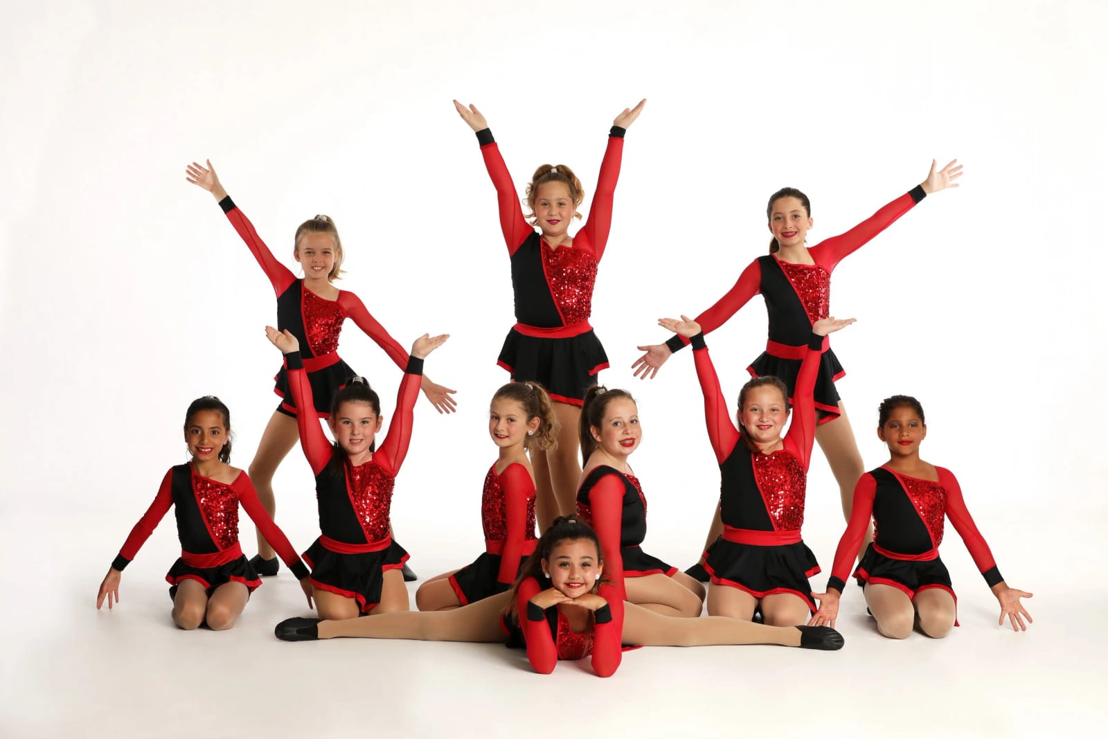 Our jazz dancers in red sequin costumes on the white studio backdrop.