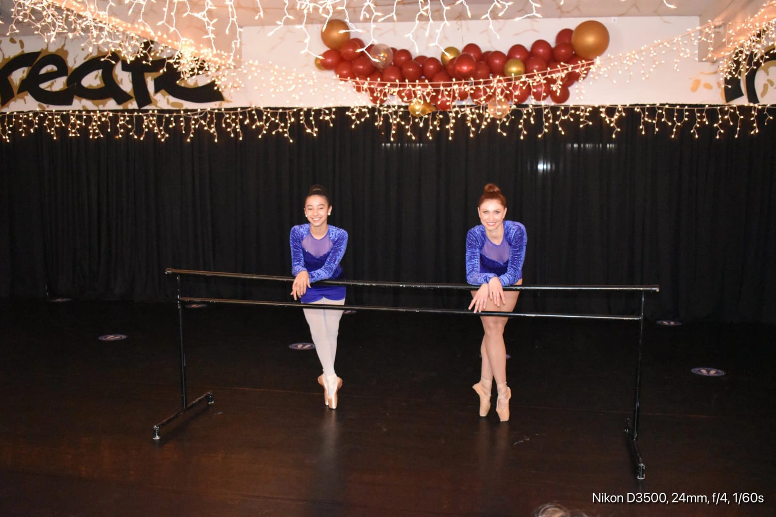 Two dancers working at a portable barre on our showcase stage.