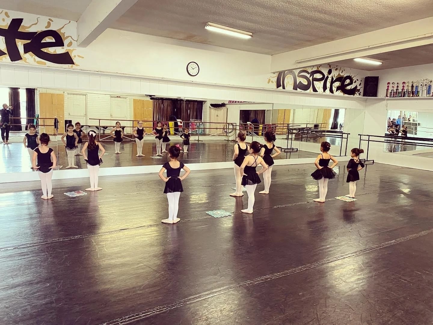 Young dancers spread across our studio floor in front of the mirrors.