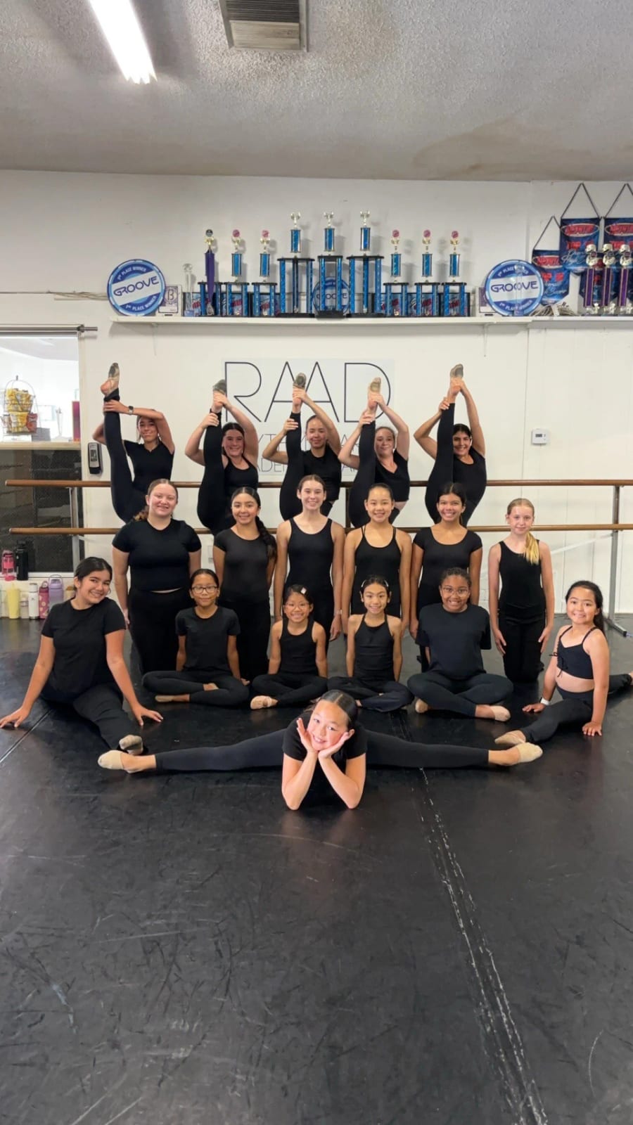 Our dancers in black gathered under the RAAD sign in the studio.