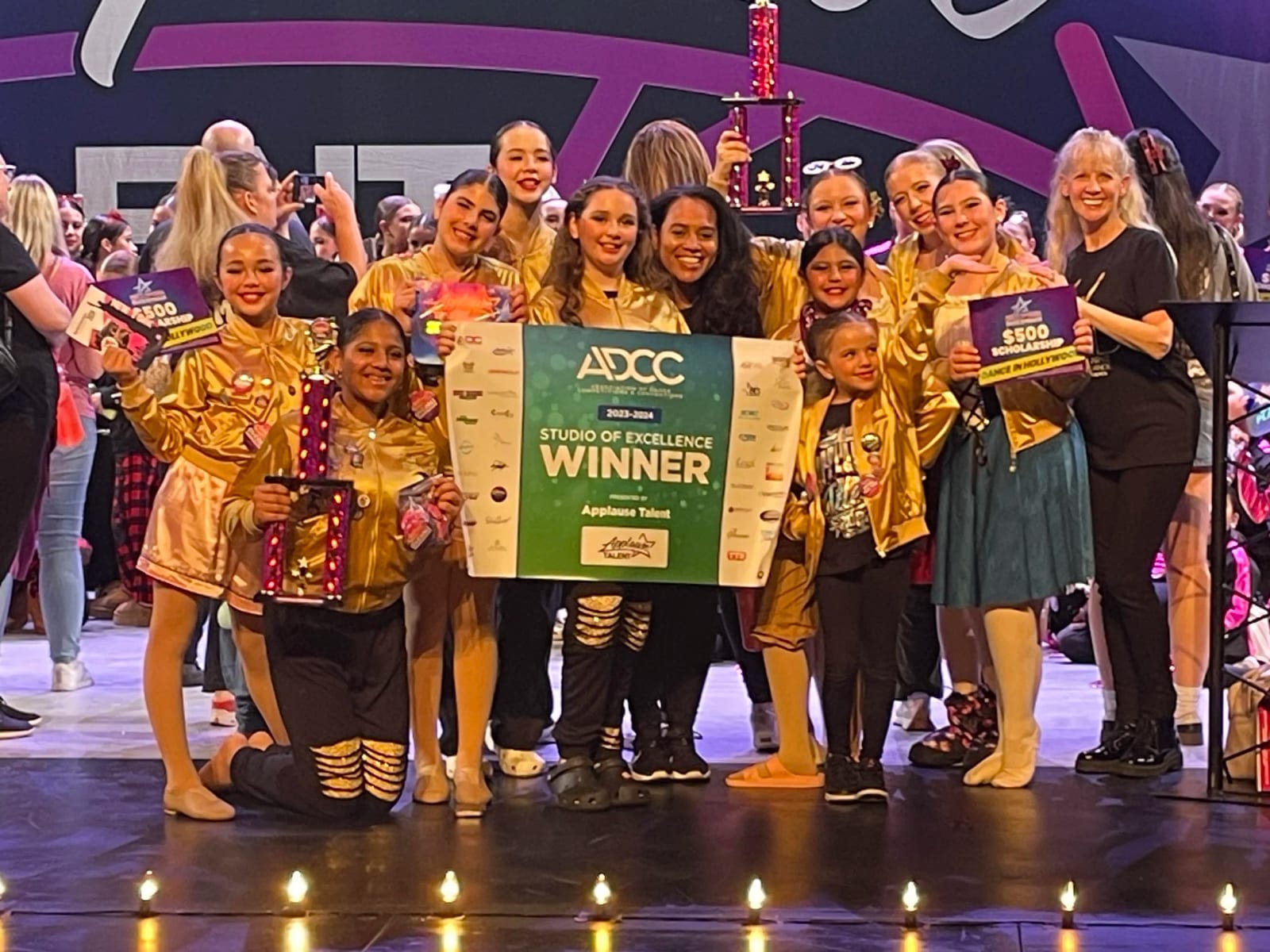 Our competition team on stage holding an ADCC Studio of Excellence winner award.